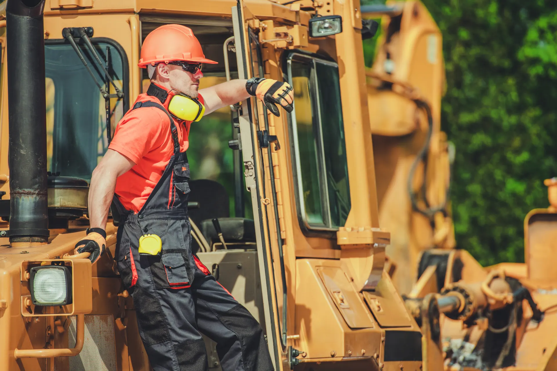 Operator climbing into the cab of a wheel loader