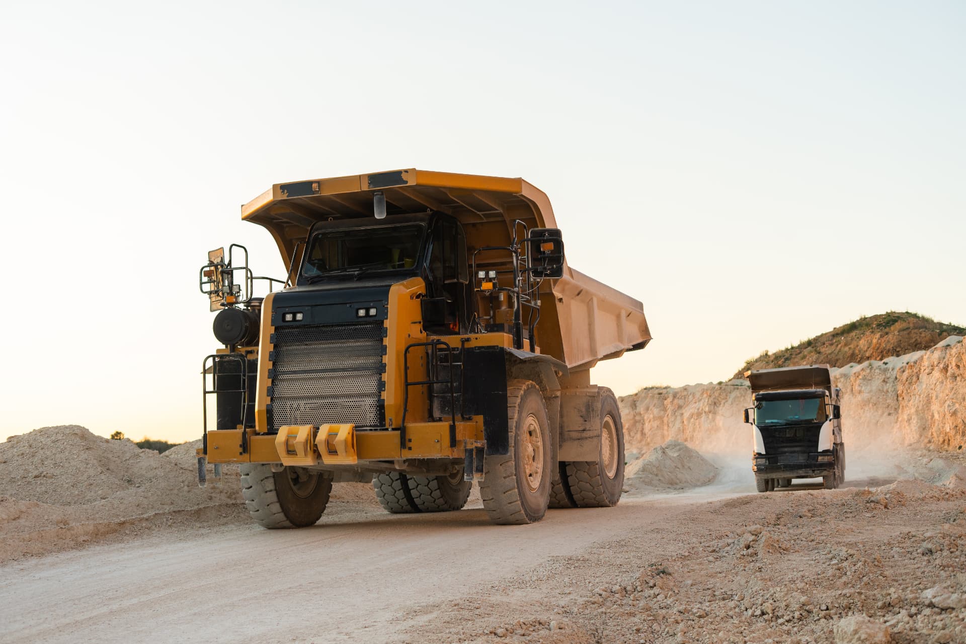 A working fleet of excavators, loaders and haul trucks across a job site